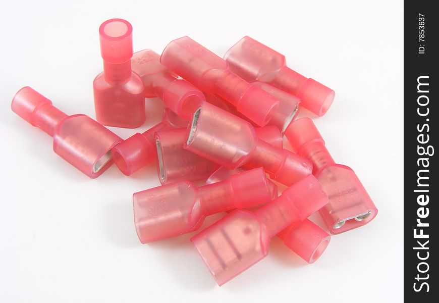 Red crimp on style electrical connectors on plain white background. Red crimp on style electrical connectors on plain white background