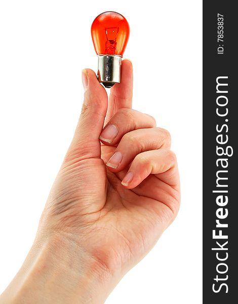 Female hand holds medical orange light bulb isolated on a white background