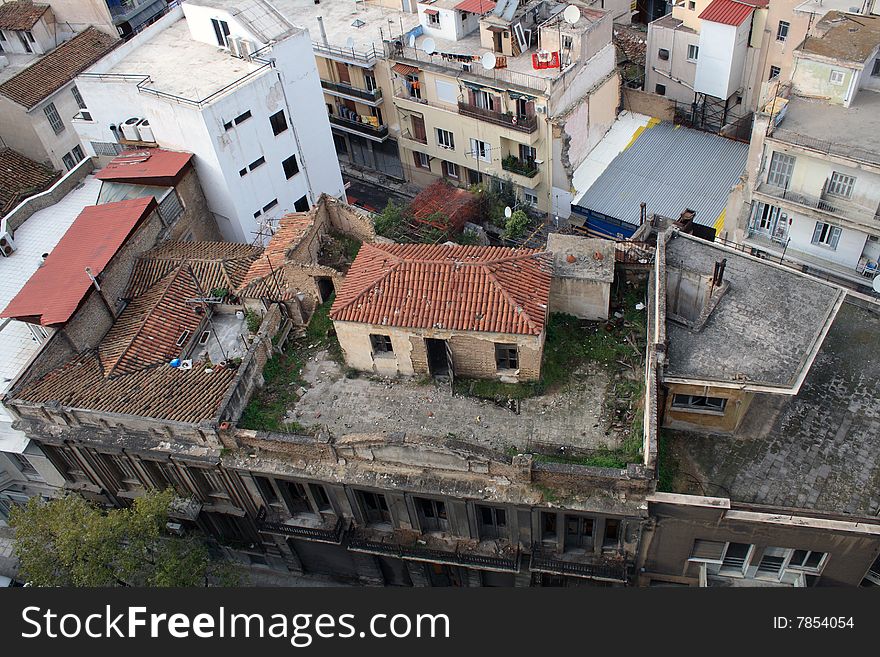 City panorama with little house standing on the roof of big building. City panorama with little house standing on the roof of big building