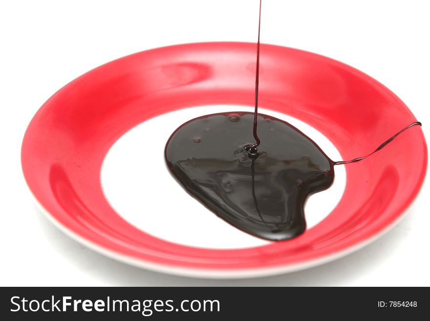 Drops Of Chocolate On A Red Plate