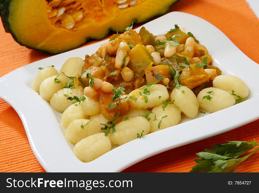 Pumpkin goulash with beans on plate