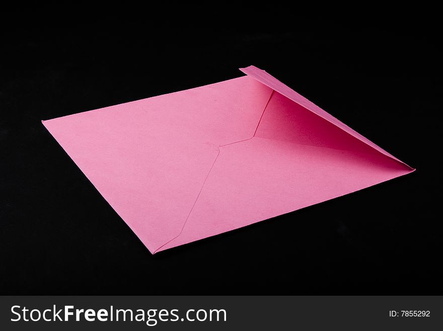 Pink envelope isolated on black background