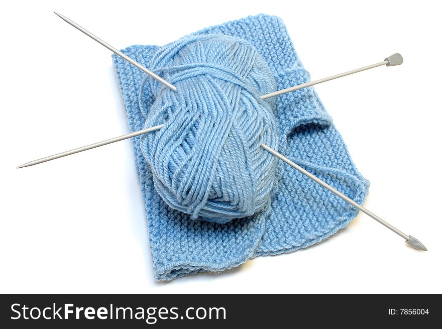 Two knitting needles, woollen yarn clew, knitting.