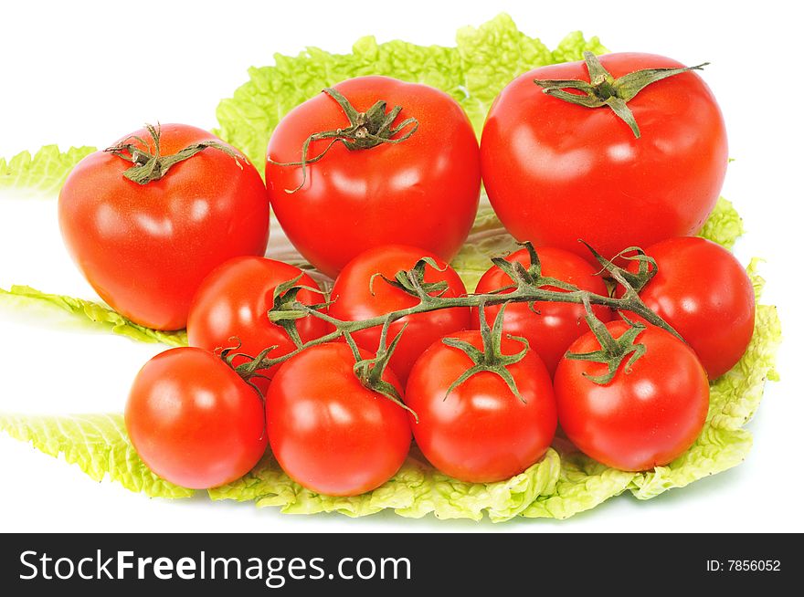 Few tomatos lie on cabbage leaves