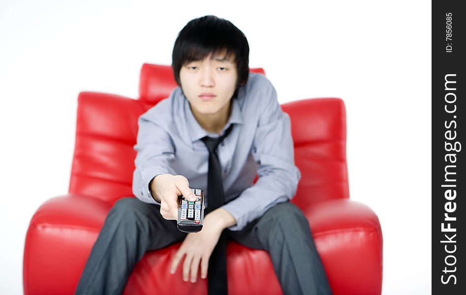 The young man in a grey shirt watches TV