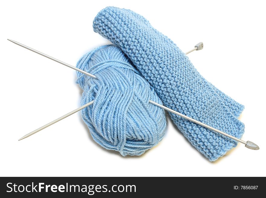 Two knitting needles, woollen yarn clew, knitting.