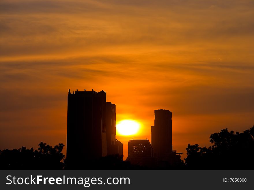 Picture of buildings with sun setting in the background. Picture of buildings with sun setting in the background.