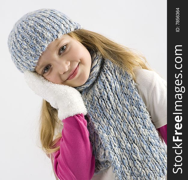 Happy young girl with cap and gloves