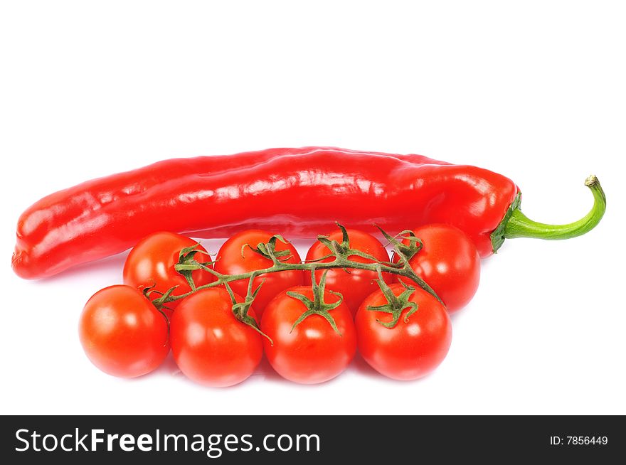 Big red pepper with few red tomatos on isolated background