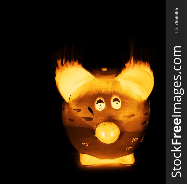 Hot flame glowing piggy bank looking at the camera. Hot flame glowing piggy bank looking at the camera