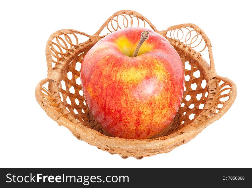 A large red apple is in a basket, on a white background