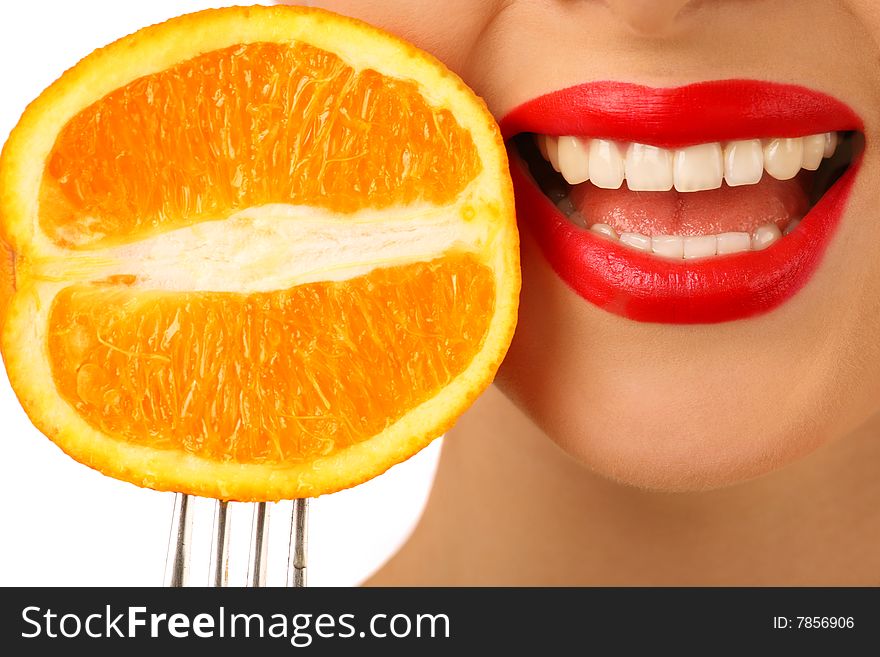 Smiling woman with orange on the fork