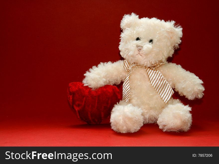 Cute teddybear holding a heart. Valentine's Day image.