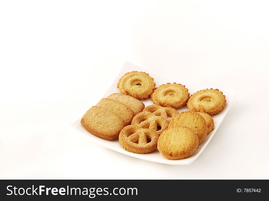 Close-up of cookies in a white plate wiith white background.