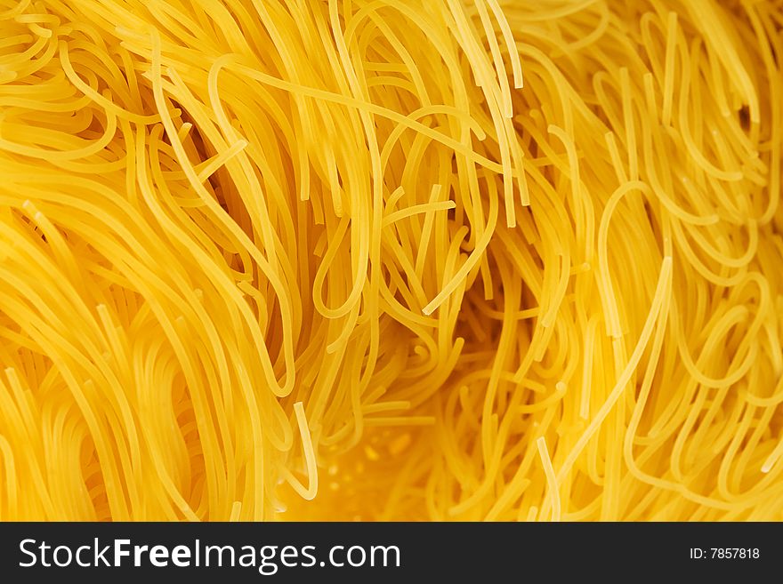 Yellow and beautiful pasta close-up as a background. Yellow and beautiful pasta close-up as a background