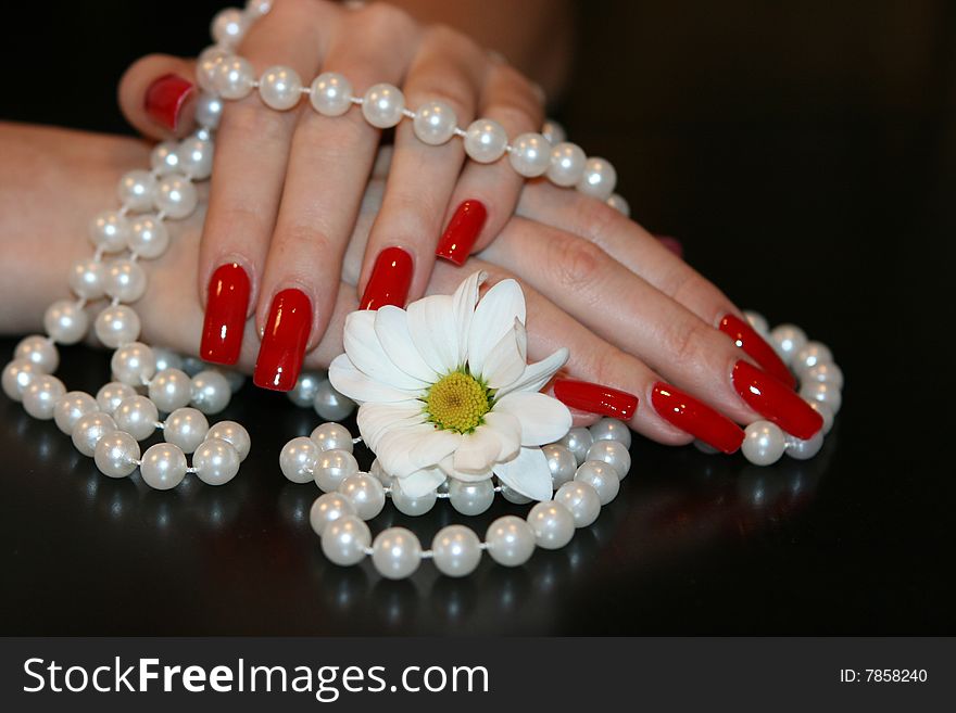 Girl holding a pearl necklace in her hands