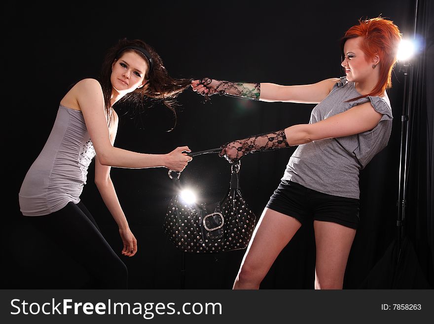 Two young models posing in the studio with backlights. Two young models posing in the studio with backlights