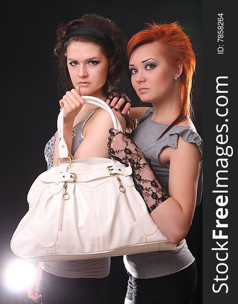 Two young models posing in the studio with backlights. Two young models posing in the studio with backlights