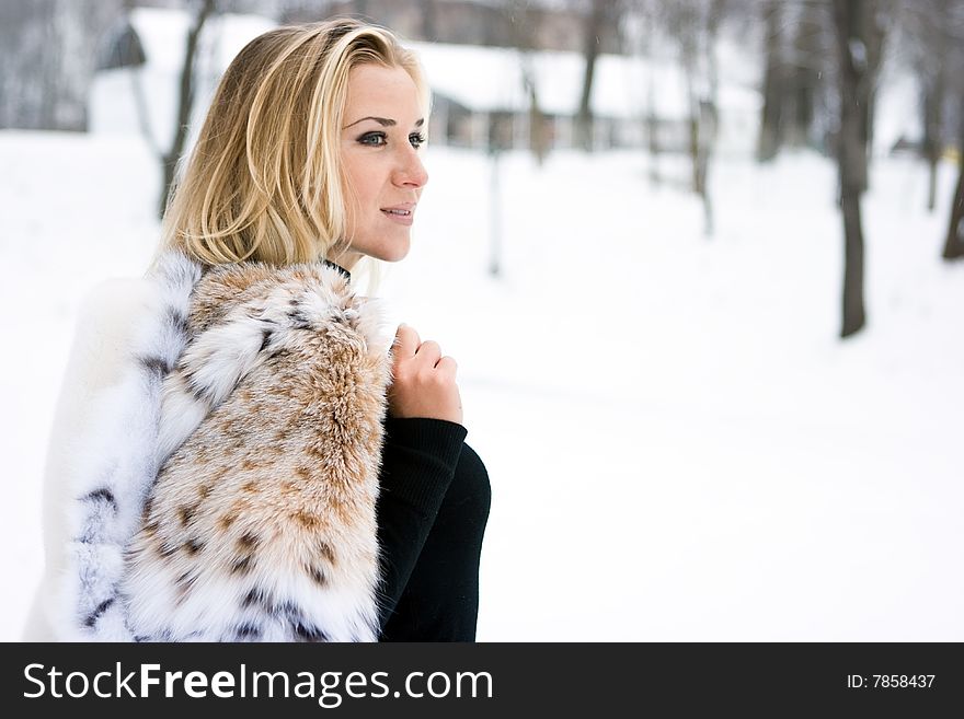 Blond girl wearing white fur coat in winter. Blond girl wearing white fur coat in winter