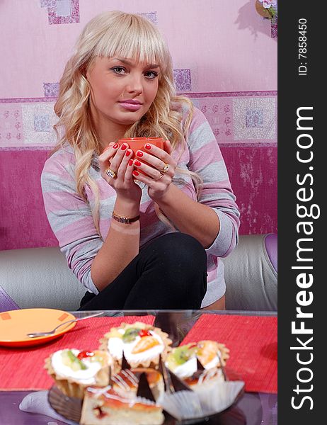 Beautiful blond woman drinking tea at the kitchen. Beautiful blond woman drinking tea at the kitchen