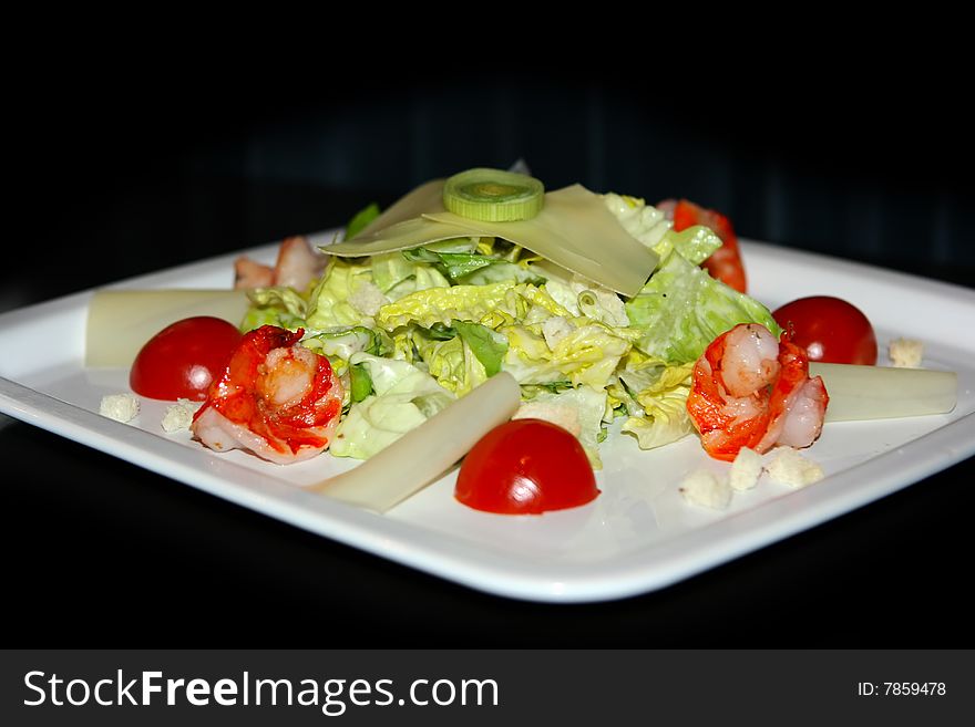 Vegetable and seafood salad on black background. Vegetable and seafood salad on black background