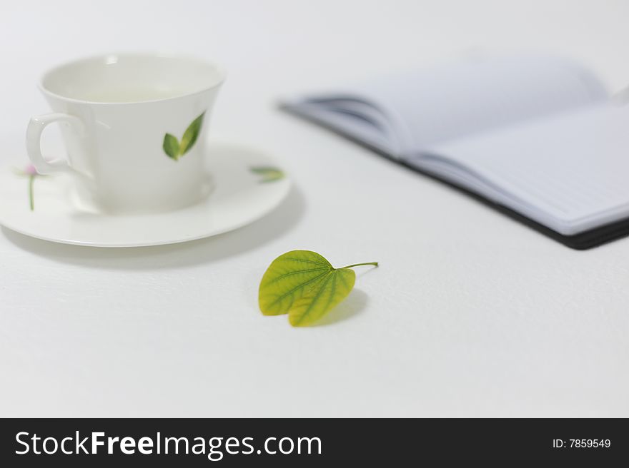 White background in the leaves, notebooks, and the cup