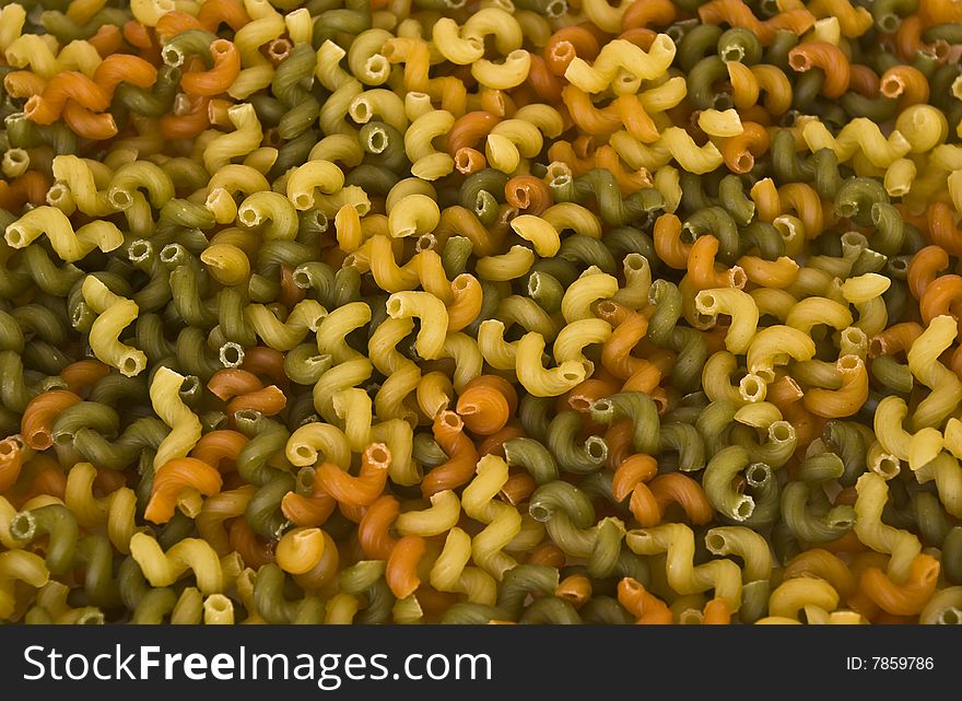 Colorful raw noodles background. Close-up. Soft focus