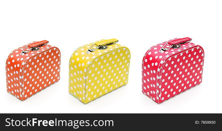 Shot of three colourful spotty cases on white