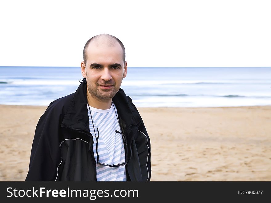 Man Close-Up Portrait On The Ocean Background. Man Close-Up Portrait On The Ocean Background