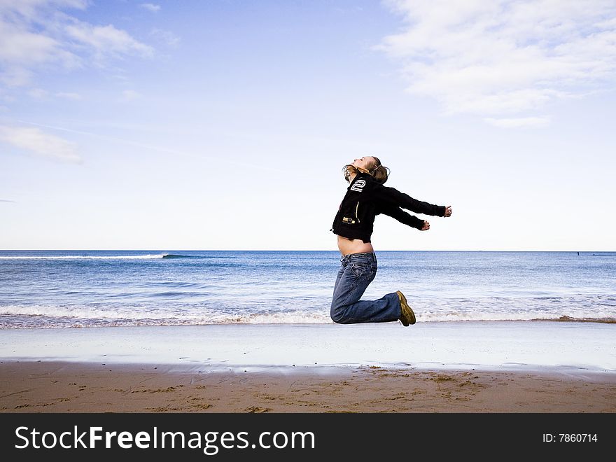 Young Woman Jumping On A Beach. Young Woman Jumping On A Beach