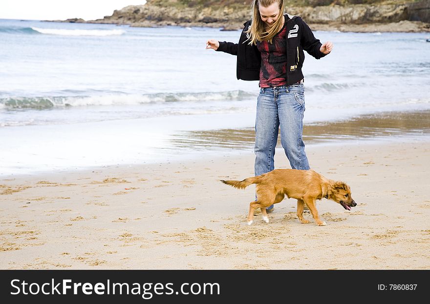 Young Woman With Dog Near The Ocean