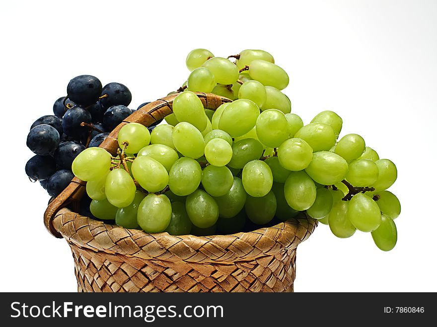 Grape in wooden basket on white