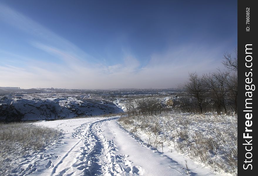 Landscape with snow evening winter road and trees