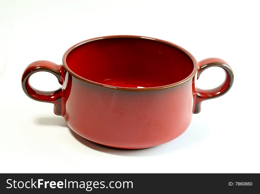 Red bowl is isolated on a white background