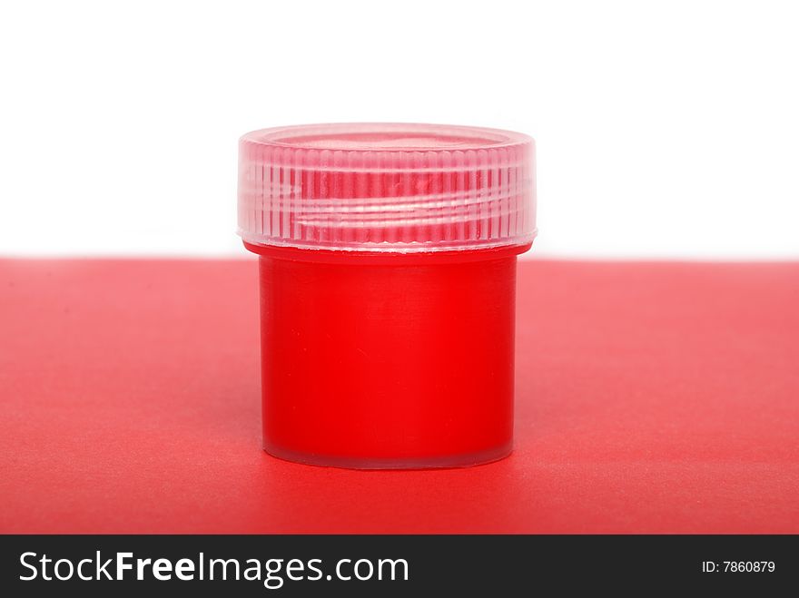 The red paint in a container with a lid