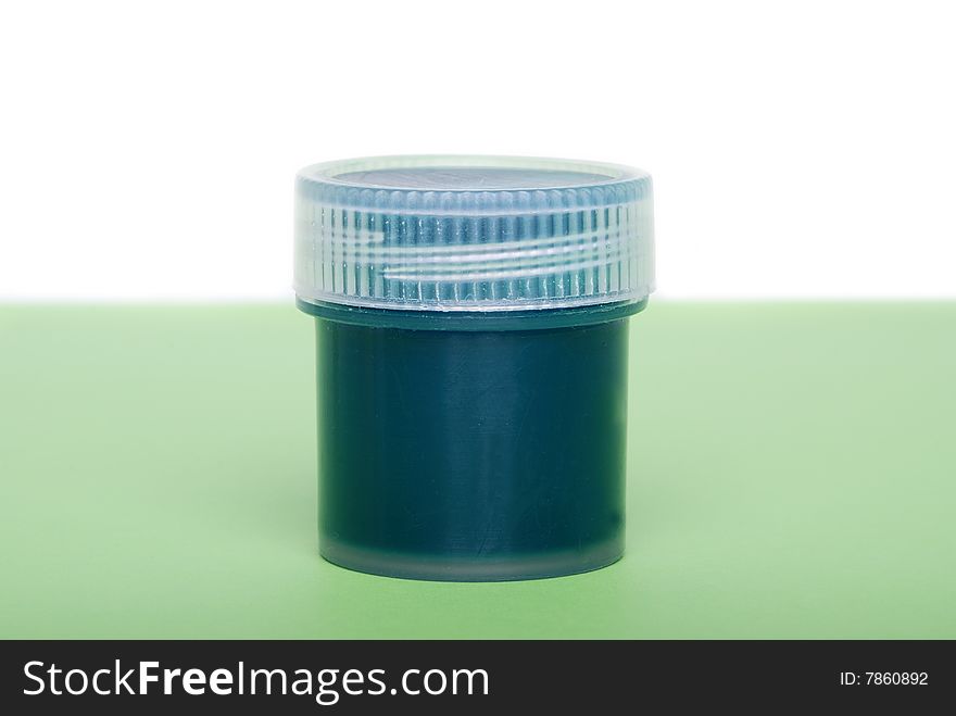 The green paint in a container with a lid