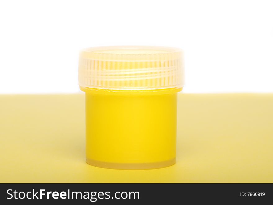 The yellow paint in a container with a lid