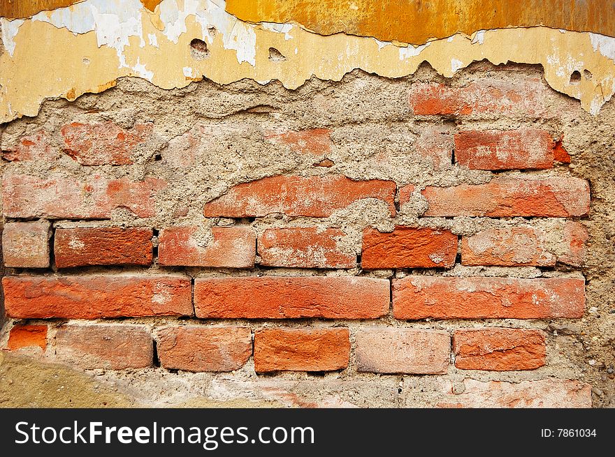 Fragment of tumbledown plastered brick wall. Fragment of tumbledown plastered brick wall