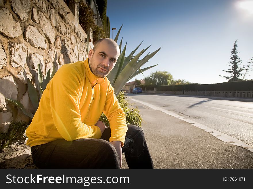 Man Sitting Near The Road. Europe Travel Series. Man Sitting Near The Road. Europe Travel Series.