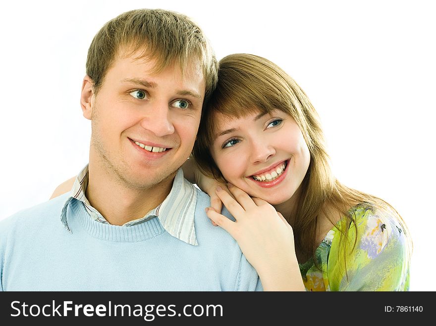Happy young embracing and laughing couple against white background. Happy young embracing and laughing couple against white background