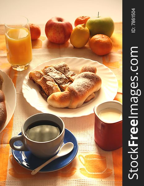 Morning meal;coffee,croissant ,bread,fruit,orange juice and milk,sepia tone. Morning meal;coffee,croissant ,bread,fruit,orange juice and milk,sepia tone