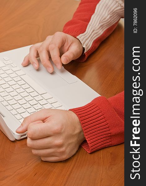 Red pullover and a wood table with laptop and a decision-maker. Red pullover and a wood table with laptop and a decision-maker