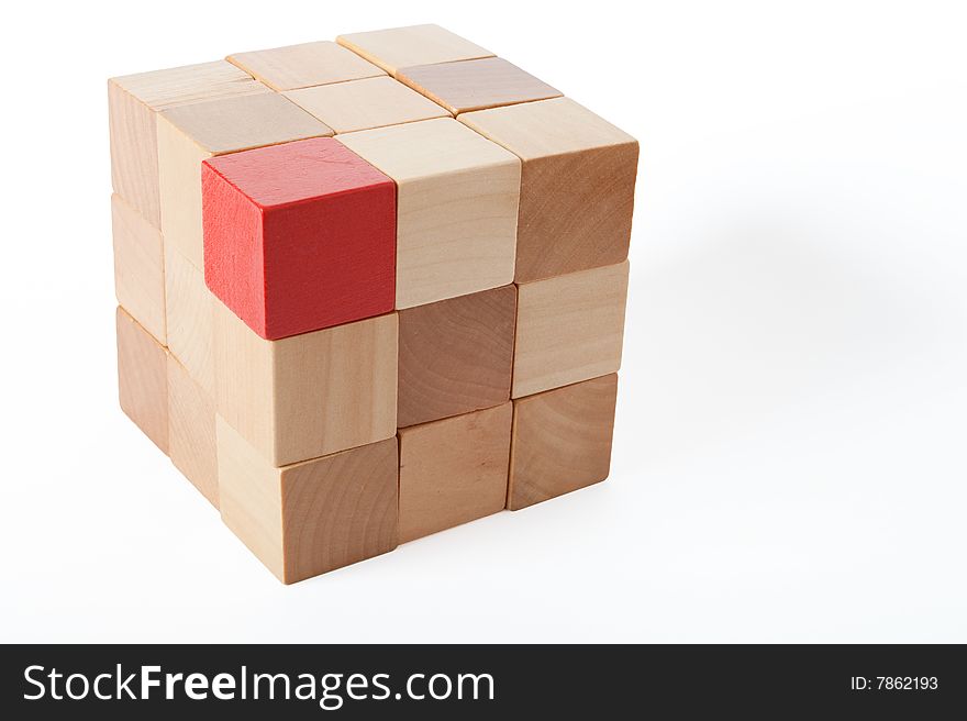 One red in a brick of brown cubes. One red in a brick of brown cubes