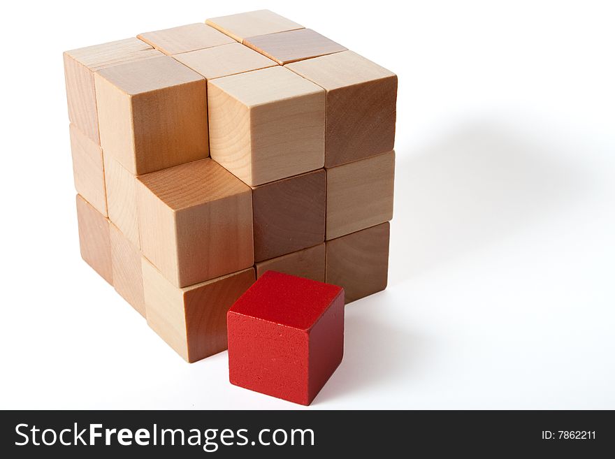 One red in a brick of brown cubes. One red in a brick of brown cubes