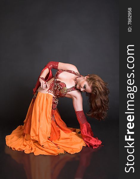 Belly Dancer wearing a red costume with jewelery. Belly Dancer wearing a red costume with jewelery