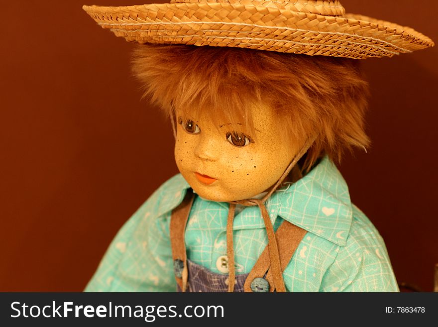 Porcelain dall face of a boy with a straw hat. Porcelain dall face of a boy with a straw hat