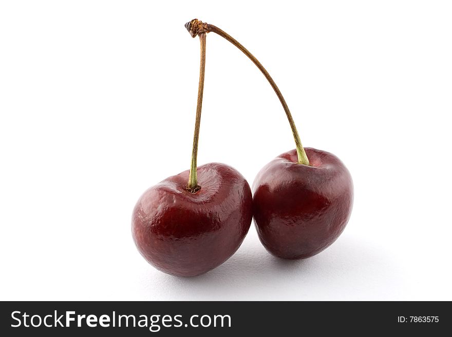 A pair of cherries isolated against a white background