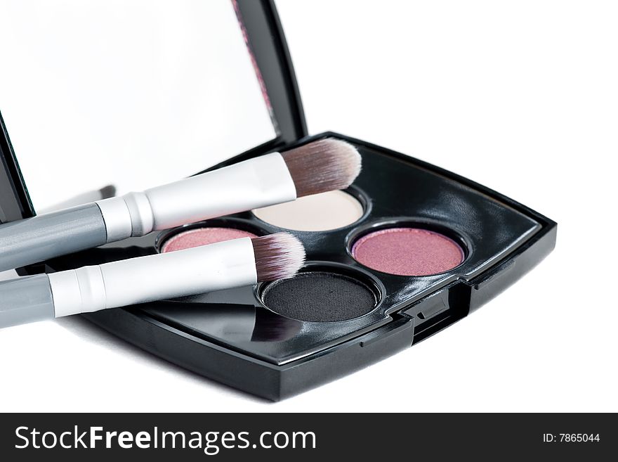 Eye shadows and make-up brushes over white