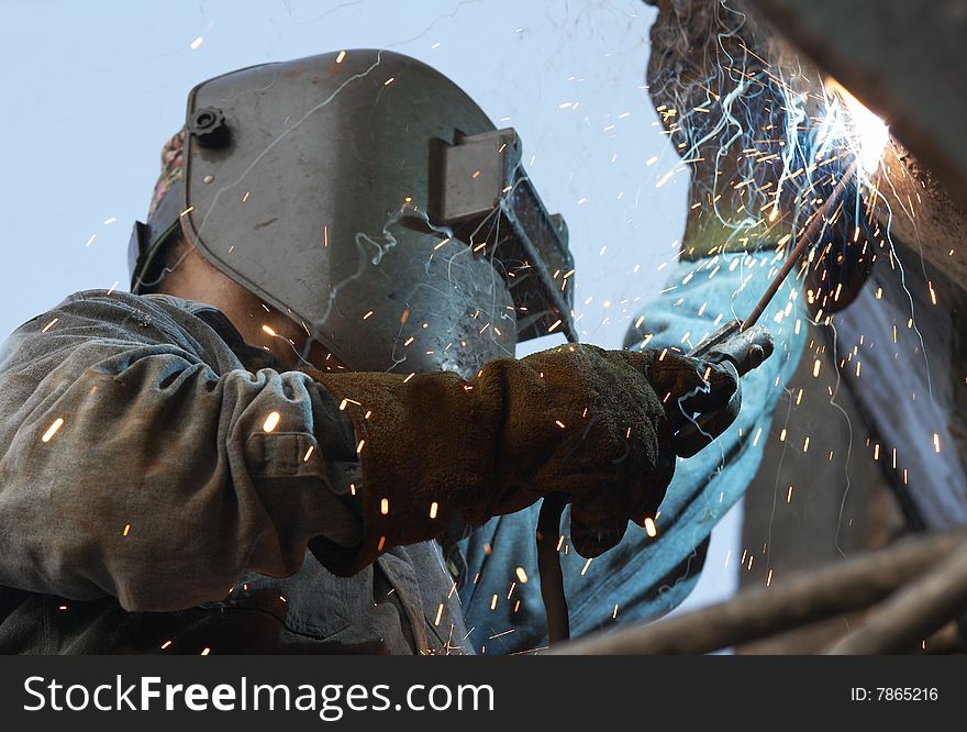 A metal welder busy at work. A metal welder busy at work