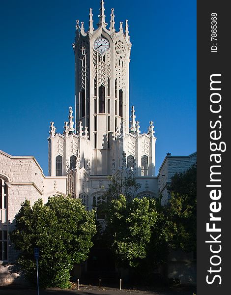 A white detailed church under blue sky